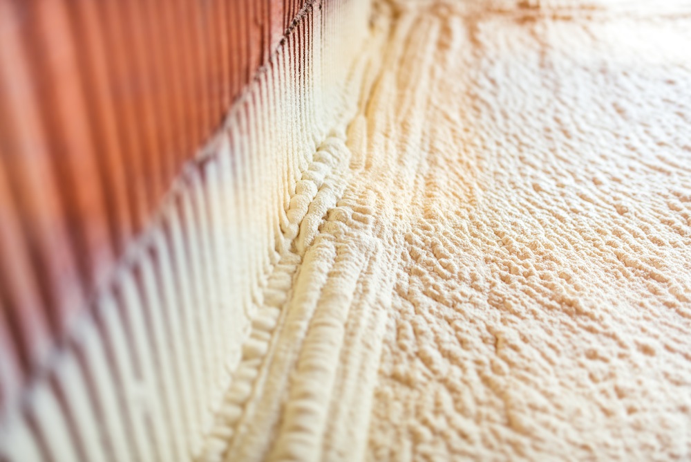thermal and hidro insulation with spray foam at house construction site