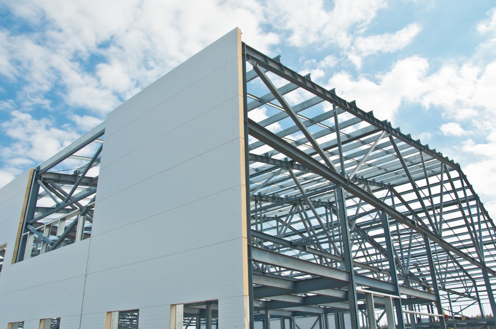Metal frame of the building with a sandwich panel of insulation on the wall