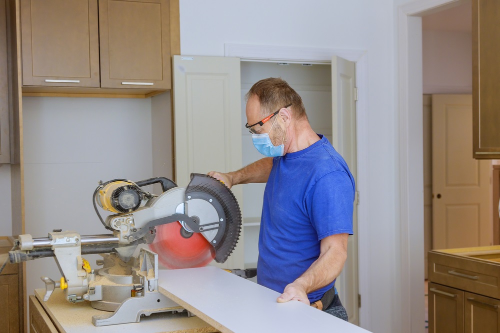 Cutting wood for cabinet with personal protective equipments
