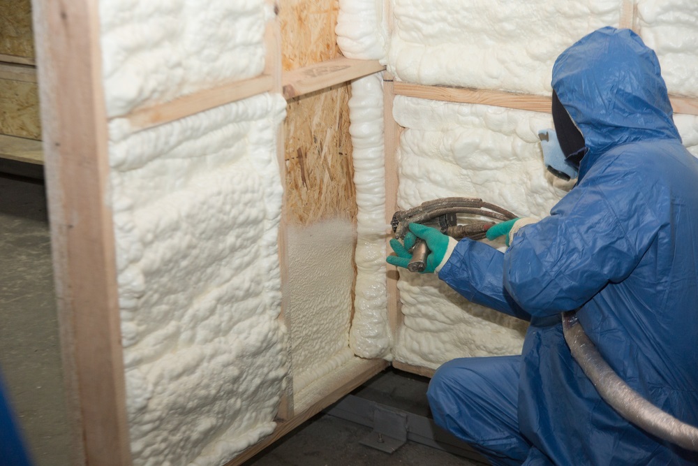 builder in a blue suit applies a construction foam builder in a blue suit applies a construction foam