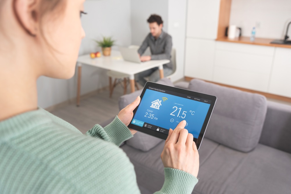 Woman using smart home application on table
