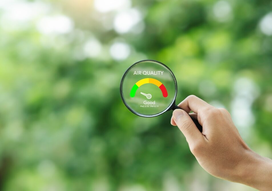 hand holding a magnifying glass to check the good air quality and clean outdoor air hand holding a magnifying glass to check the good air quality and clean outdoor air