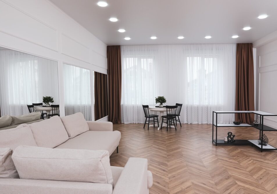 Modern room with parquet flooring and stylish furniture Modern room with parquet flooring and stylish furniture