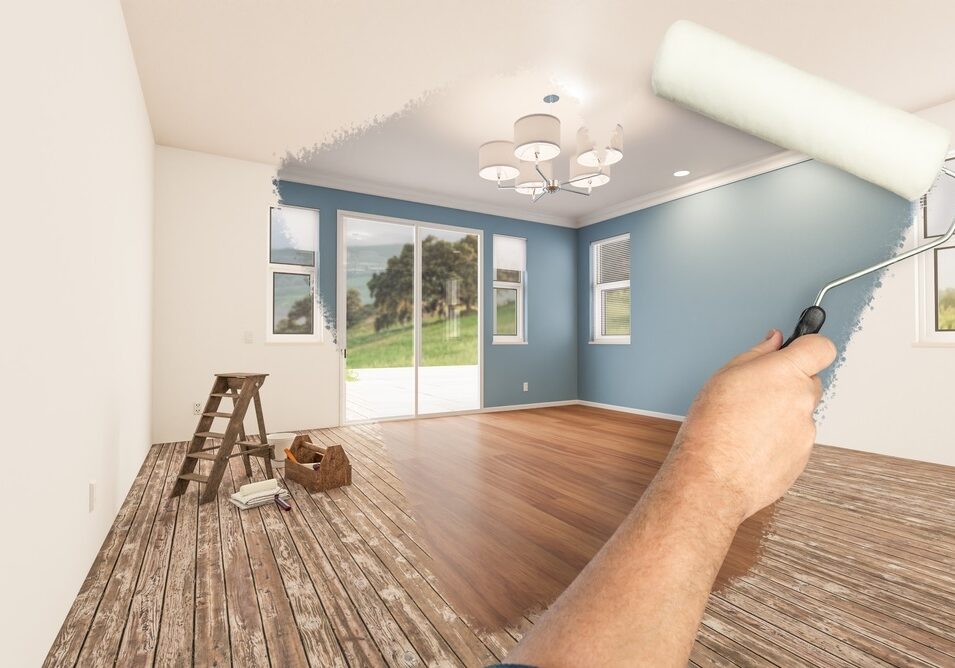 Before and After of Man Painting Roller to Reveal Newly Remodeled Room with Fresh Blue Paint and New Floors Before and After of Man Painting Roller to Reveal Newly Remodeled Room with Fresh Blue Paint and New Floors