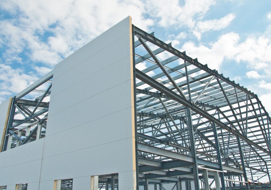 Metal frame of the building with a sandwich panel of insulation on the wall Metal frame of the building with a sandwich panel of insulation on the wall