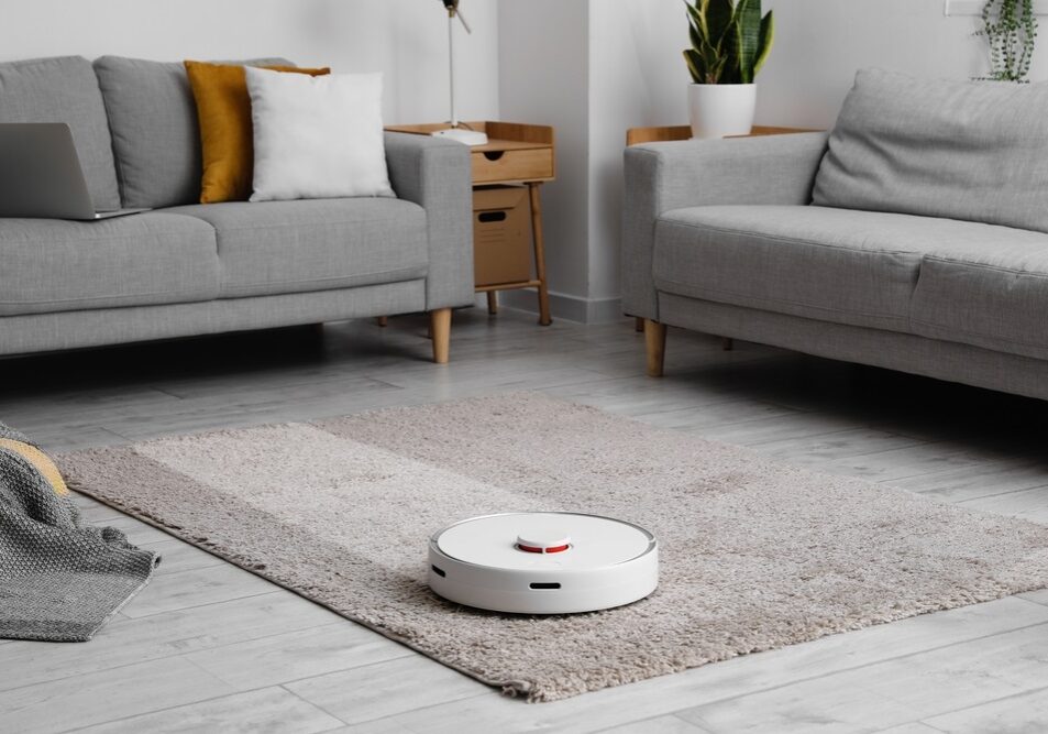 Modern robot vacuum cleaner on soft carpet in room Modern robot vacuum cleaner on soft carpet in room