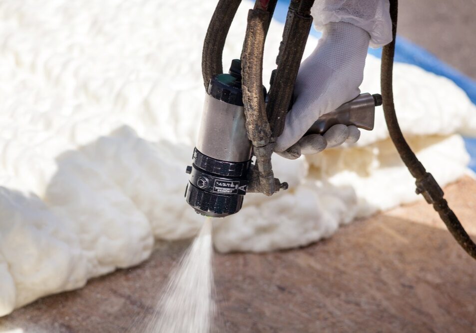 Technician spraying foam insulation using Plural Component Spray Gun Technician spraying foam insulation using Plural Component Spray Gun