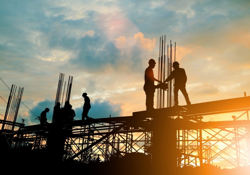 Silhouette of engineer and construction team working at site Silhouette of engineer and construction team working at site