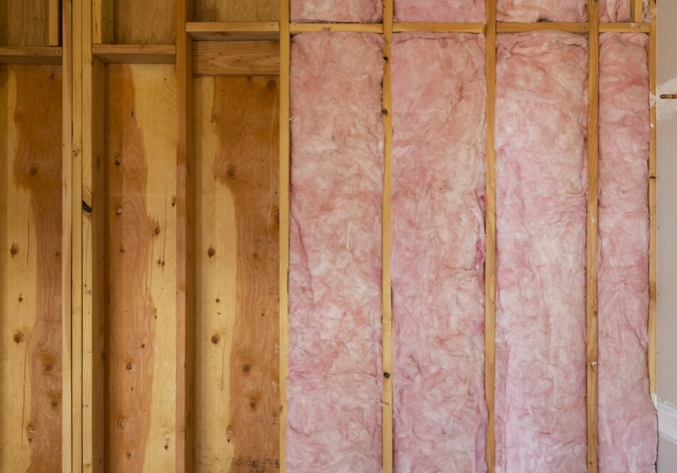 Horizontal Close Up of Fiberglass Installation in New Home Construction Horizontal Close Up of Fiberglass Installation in New Home Construction